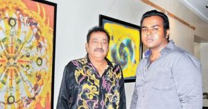 Pandu with his son in an exhibition of paintings made by Pandu