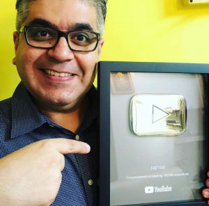 Rajeev Masand showing his Silver Play Button Received for his YouTube Channel