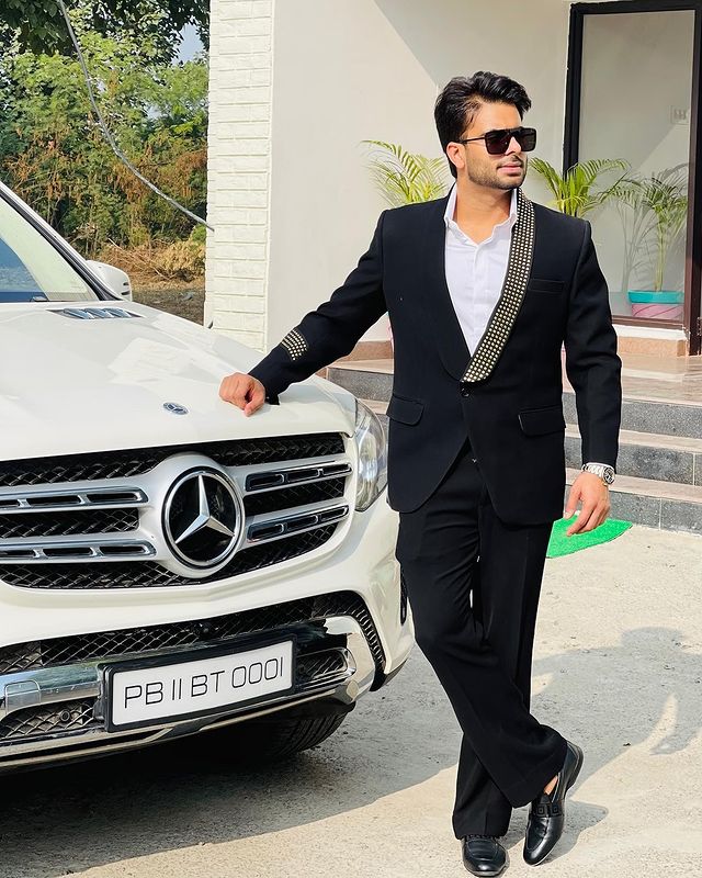 Mankirt Aulakh with one of his lavish cars